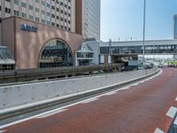 an empty street that leads to buildings on either side and a bridge crossing over the road