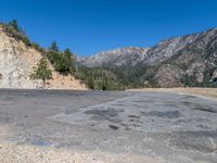 the dirt road has been cleared out by mountains and trees in it's direction