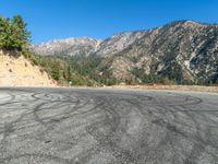 a tire is painted on the road near the mountains in this photo is taken from a car