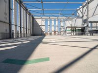 the view from the inside of a large building with green arrows pointing left out into a sky