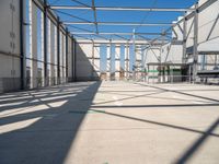 the view from the inside of a large building with green arrows pointing left out into a sky