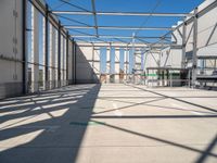 the view from the inside of a large building with green arrows pointing left out into a sky