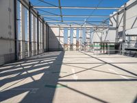 the view from the inside of a large building with green arrows pointing left out into a sky