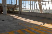 a yellow crosswalk in a building with large windows and light coming through it that says