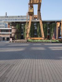 a clock tower sitting in the middle of a wooden courtyard on a sunny day in the city