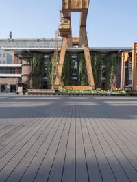 a clock tower sitting in the middle of a wooden courtyard on a sunny day in the city