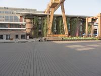 a clock tower sitting in the middle of a wooden courtyard on a sunny day in the city