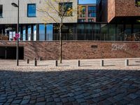 the large building is made of concrete and has metal railings around it, which are made of brick