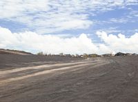 a paved roadway runs down the side of the hill near construction area with a construction vehicle