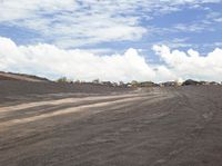 a paved roadway runs down the side of the hill near construction area with a construction vehicle