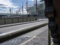 there is a very large view through the rail of this building while traffic goes past it