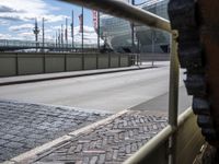 there is a very large view through the rail of this building while traffic goes past it