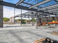 an empty construction yard with a concrete floor and metal structures for workers to construct in