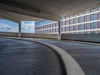 a car is driving on the highway through an underground parking garage area in a city