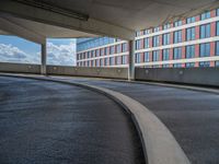 a car is driving on the highway through an underground parking garage area in a city