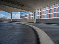 a car is driving on the highway through an underground parking garage area in a city