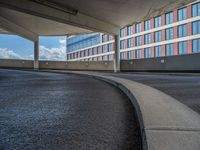 a car is driving on the highway through an underground parking garage area in a city