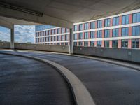 a car is driving on the highway through an underground parking garage area in a city