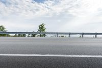 a road near an overpass with a bridge above it on the horizon below it