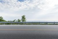 a road near an overpass with a bridge above it on the horizon below it