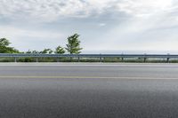 a road near an overpass with a bridge above it on the horizon below it