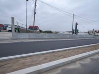 an area near some traffic with a construction site in the background on a grey cloudy day