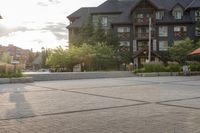 a man riding a skateboard on top of a brick sidewalk of some sort at sunset