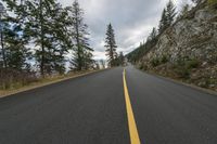 the road is empty and it looks good to be a mountain trail climber is riding