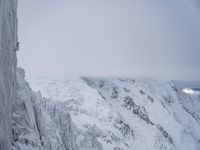 Cloudy Landscape: Gloomy Mountains Covered in Snow