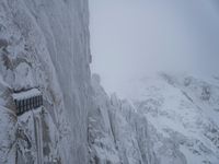 Cloudy Landscape: Gloomy Mountains Covered in Snow