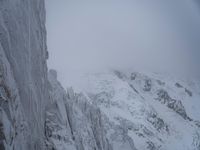 Cloudy Landscape: Gloomy Mountains Covered in Snow