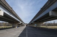 two highway arches that have been built into each other in a parking lot in a park