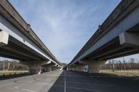 two highway arches that have been built into each other in a parking lot in a park