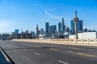 empty highway with city skyline in background and no cars on it and signs on it