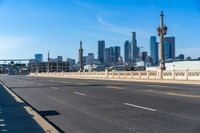 empty highway with city skyline in background and no cars on it and signs on it