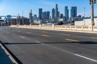 empty highway with city skyline in background and no cars on it and signs on it