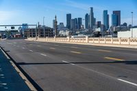 empty highway with city skyline in background and no cars on it and signs on it