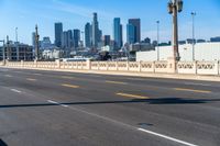 empty highway with city skyline in background and no cars on it and signs on it