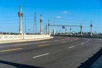 a view of an empty highway and the sky is blue with a few clouds in the sky