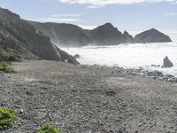 a view of the beach at low tide on the coast near the rocky cliffs and water