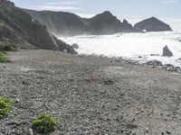 a view of the beach at low tide on the coast near the rocky cliffs and water