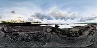 the image of a panoramic beach with clouds and water behind it and the sun shining in to the sky