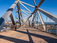 metal beams are painted blue and white on the bridge crossing the ocean in sydney, australia