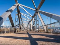 metal beams are painted blue and white on the bridge crossing the ocean in sydney, australia