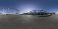 a series of three shots showing a roller coaster and other rides in the background while it sun shines