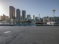 the sun shines brightly on the waterfront in the cityscape of sydney with boats and skyscrapers