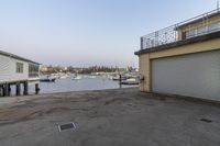 a small boat is docked in an empty dock outside a building and building on the water