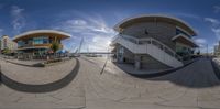 360 - image of an outdoor area that has steps and steps to different buildings, the sun in the background