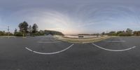 a view of the sky from a fish eye lens with a bench and benches in front