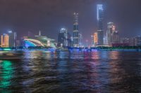 a city street with buildings and neon lights at night time in hong china as seen from an empty city highway